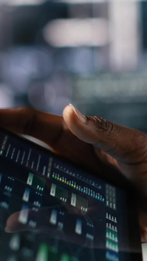 Vertical video Close up of data center software developer using tablet to review Stock Footage 313455950