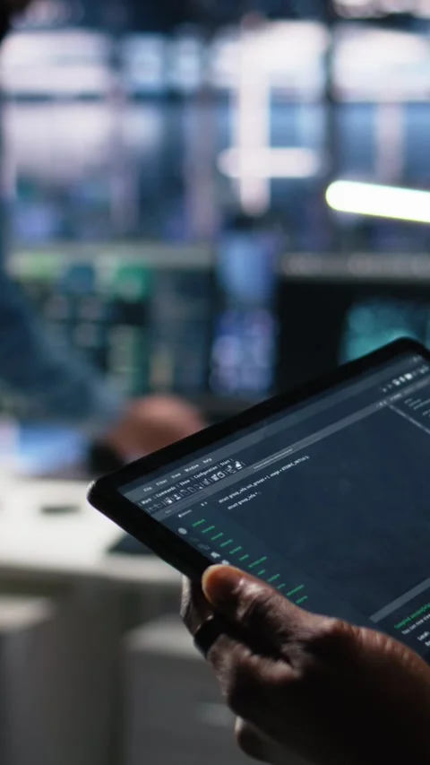 Vertical video Close up of data center software developer using tablet to review Stock Footage 313507892