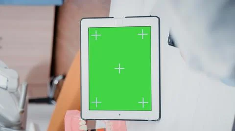 Vertical video: Close up of dentist using green screen on tablet Stock Photos