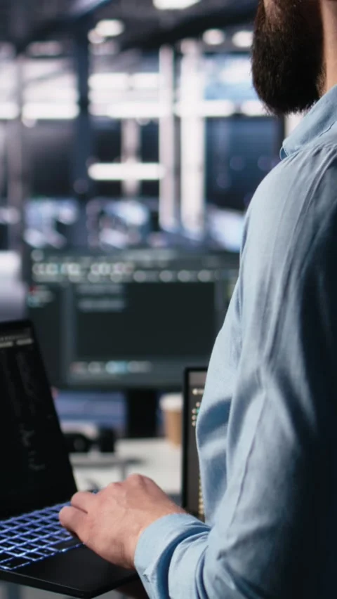 Vertical video Close up of developer in data center coding with generative AI on Stock Footage 313456772