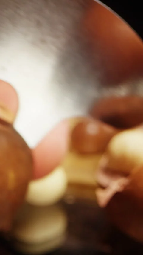 Vertical video. Close Up Dolly Slider Shot of Macadamia Nuts with Special Metal Stock Footage 324561404