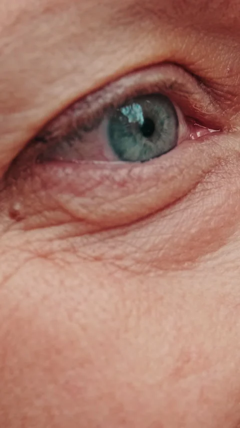 Vertical video, Close-Up: Elderly Woman's Expressive Eyes and Wrinkles Stock Footage 314637879