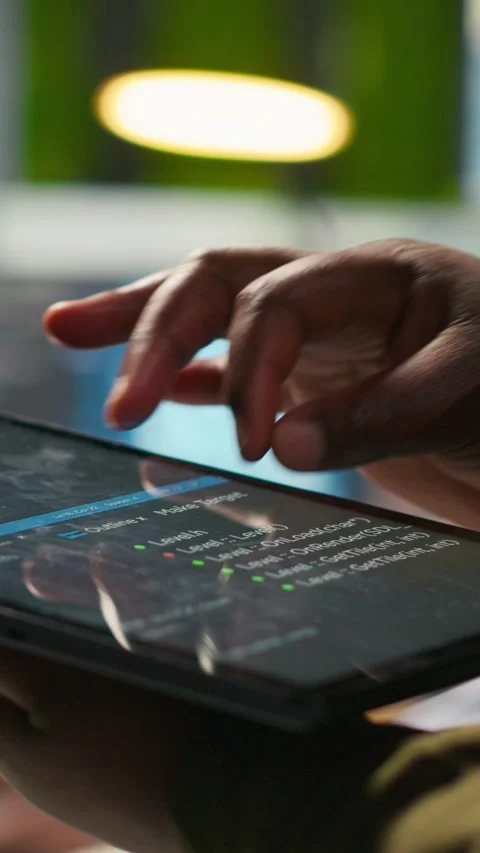 Vertical video Close up of engineer using tablet to write code, developing Stock Footage 312709477