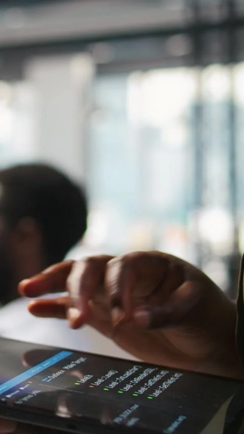 Vertical video Close up of engineer using tablet to write code, developing Stock Footage 312769585