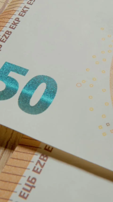Vertical video Close up exploration of a 50 euro banknote showcasing intricate Stock Footage 327596408