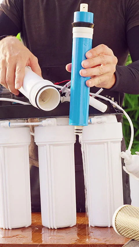 Vertical video. Close Up Extraction of Old Membrane Cartridge From Reverse Osmos Stock Footage 335214717