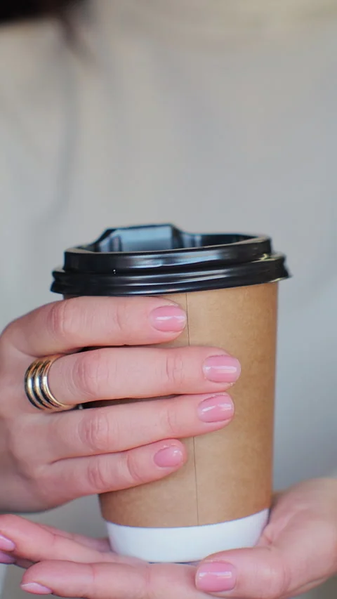 Vertical video. Close up female hand barista giving cup of coffee to camera Vídeo Stock 344108160