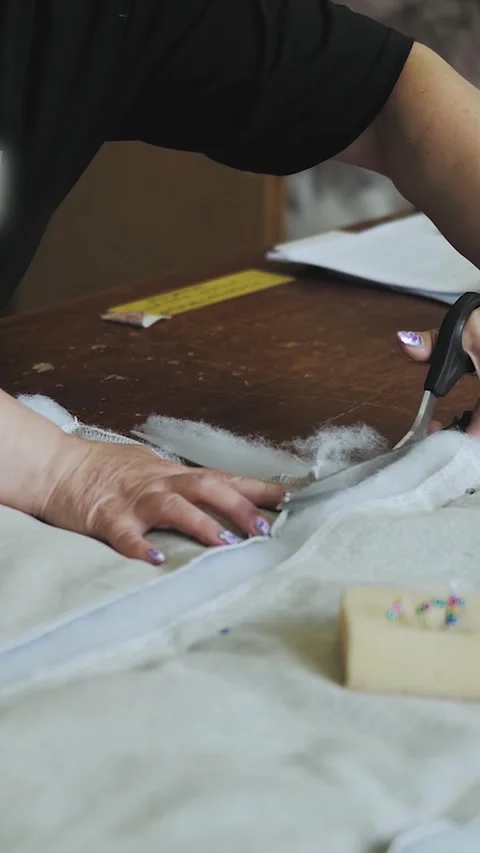 Vertical video. Close-up of female hands cutting foam rubber fabric with Stock Footage 323451219