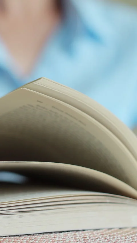 Vertical video Close-up of female hands turning page book. Stock Footage 338086568