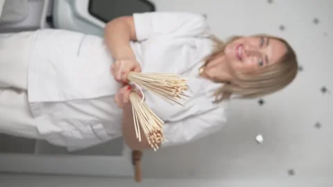Vertical video. Close up of female masseuse with wooden massage tools Stock Footage 296077952