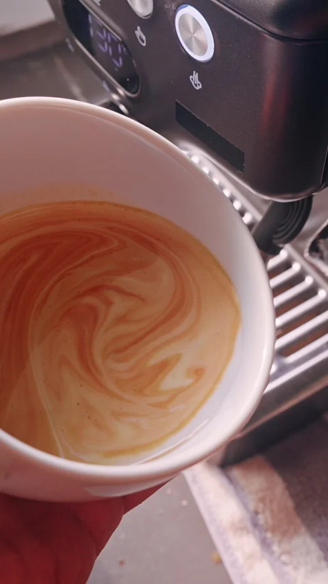 Vertical video. Close Up First Person View Pouring Remaining Steamed Milk Into L Stock Footage 331024059