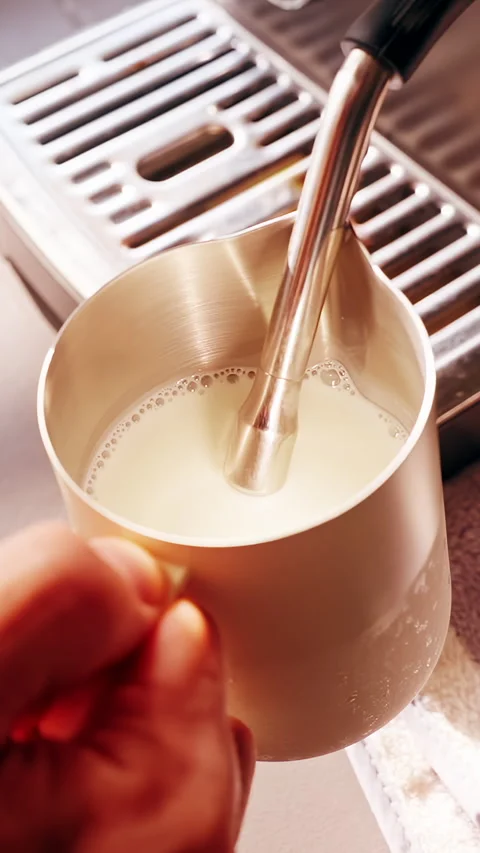 Vertical video. Close Up First Person View Adjusting Milk Pitcher During Frothin Stock Footage 331025775