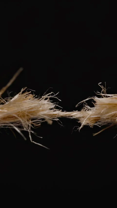 Vertical video. Close-up of a frayed rope on the verge of snapping, showing Stock Footage 296087333
