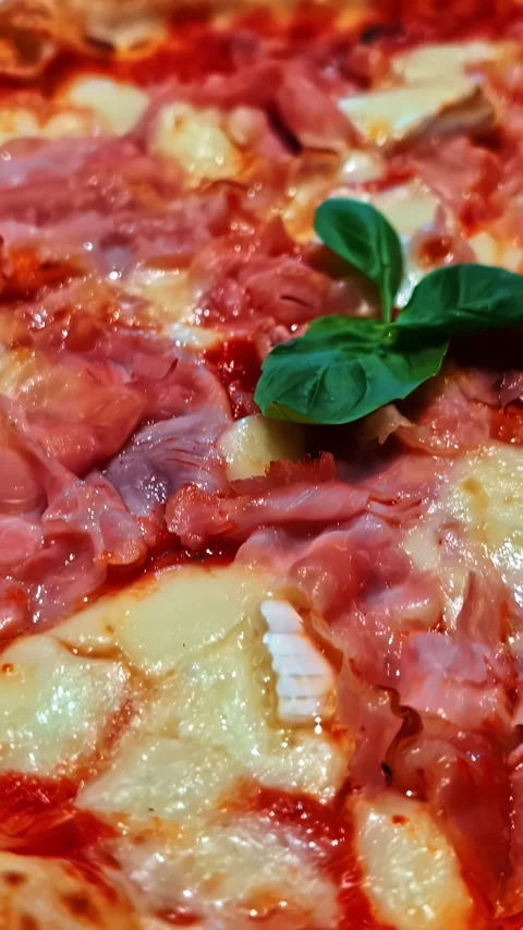 Vertical Video - Close-up of Freshly Baked Pizza with Basil Topping Stock Footage 337929294