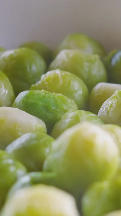 Vertical Video Close-up of Freshly Steamed, Vibrant Green Brussels Sprouts Stock Footage 327365113
