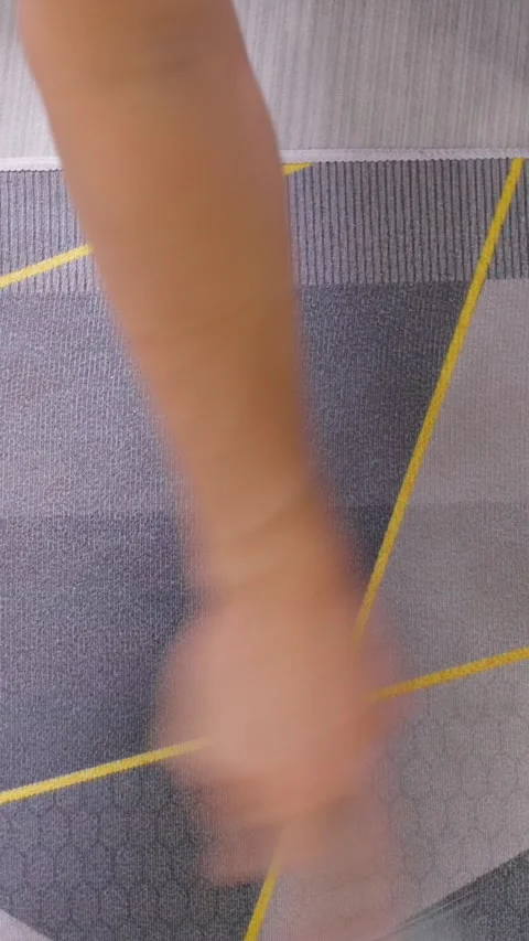Vertical video. Close Up of Hand Scrubbing Carpet with Small Brush on Patterned Stock Footage 315236428