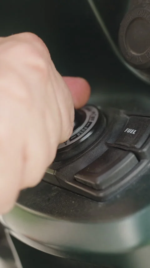 Vertical video. Close-Up of Hand Turning Key in Scooter Ignition Switch Before Stock Footage 310085018