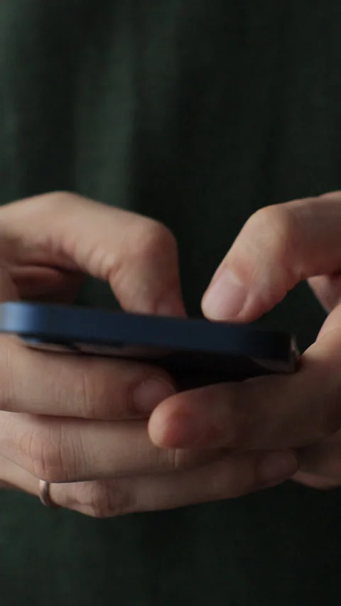 Vertical video. Close up of hands of caucasian man using smartphone at home. Видео 343764081