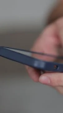 Vertical video Close up of hands of man writes a text message on smartphone i Stock Photos