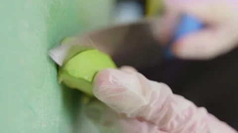 Vertical video. Close up of hands slicing half an avocado on cutting board Stock Footage 240251836