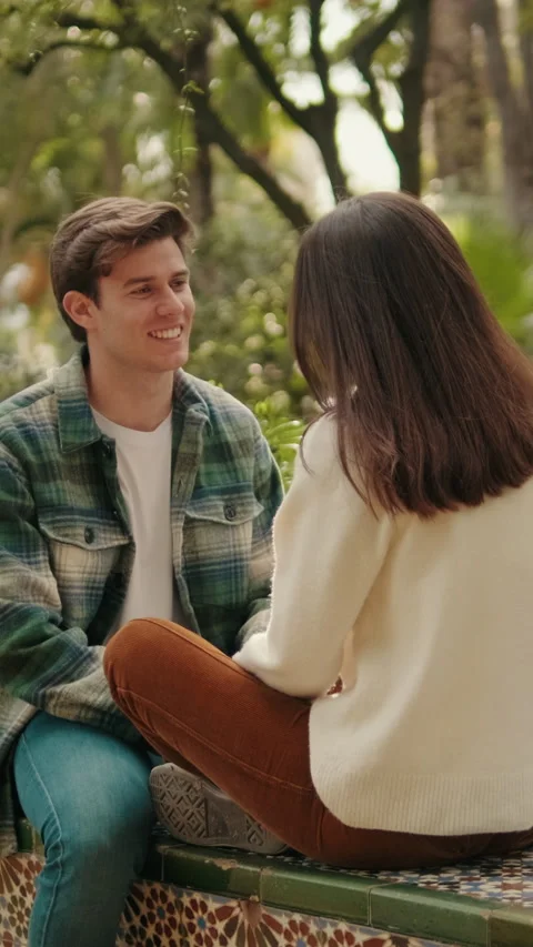 Vertical video, Close-up, happy young couple man and woman talking sitting in Stock Footage 297616165