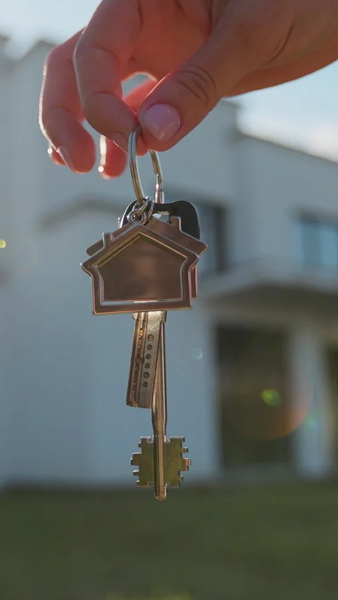 Vertical video Close-up of house key in the hand of woman house Stock Footage 338088280