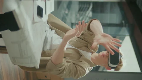 Vertical Video, Close-up.Immerced Young Architect Wearing VR Headset during Work Stock Footage 239107951