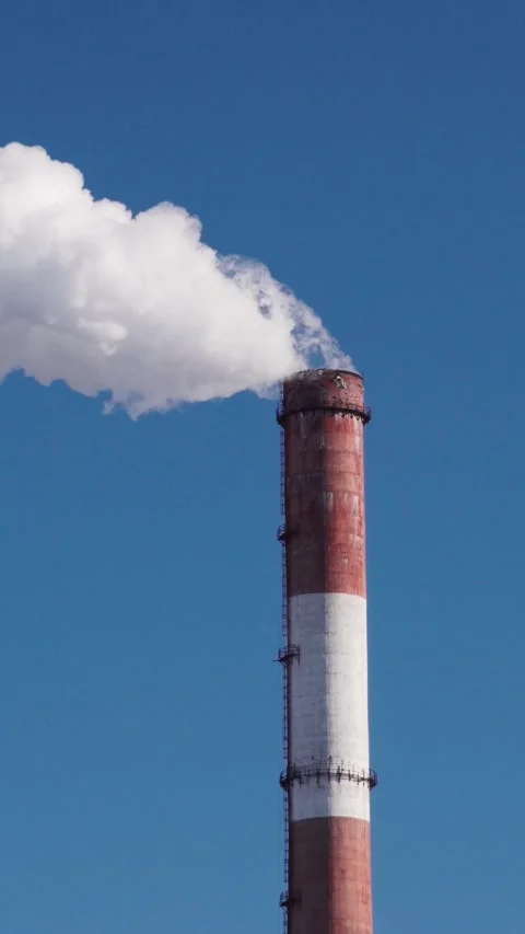 Vertical video close up of industrial cooling tower top with steam against sky Stock Footage 345212399