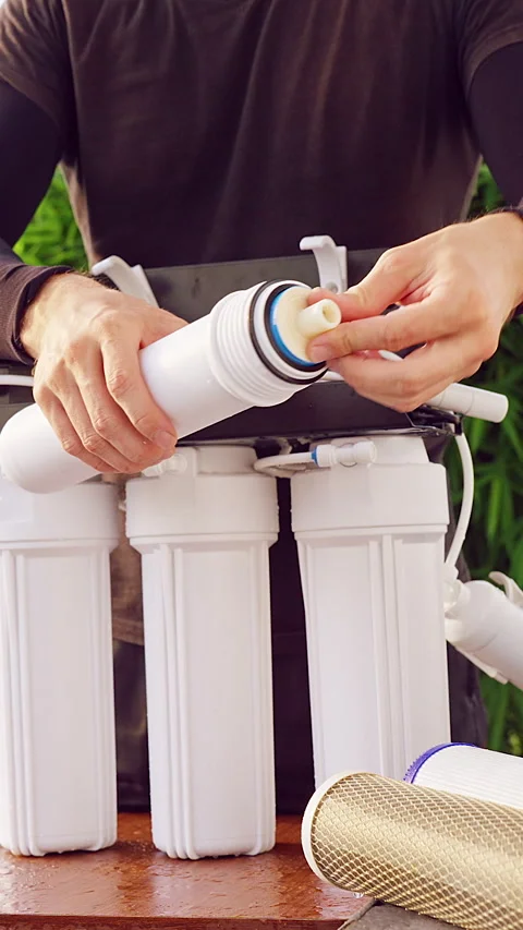 Vertical video. Close Up Installation of New Reverse Osmosis Membrane Cartridge Stock Footage 335214807