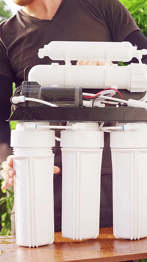 Vertical video. Close Up Installation of Reverse Osmosis Water Filter System on Stock Footage 335214685