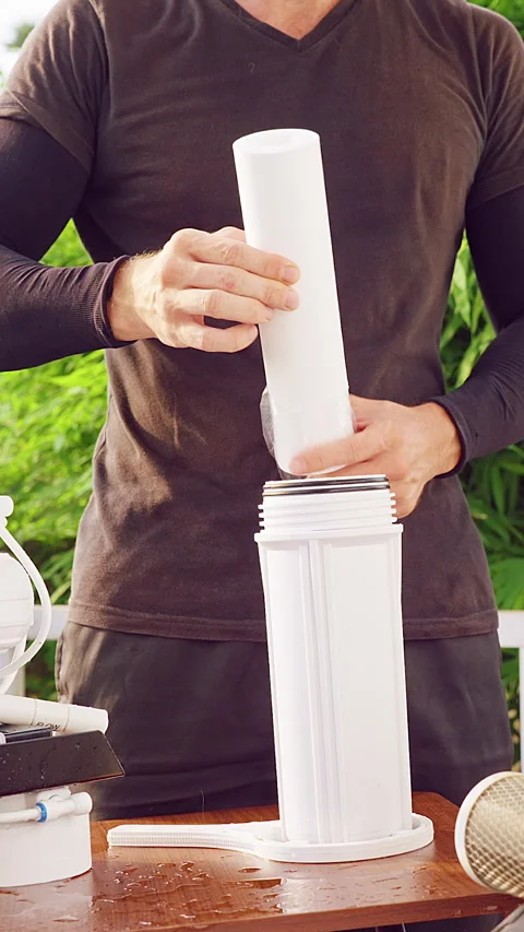 Vertical video. Close Up Installation of Sediment Filter Cartridge Into Reverse Stock Footage 335214490