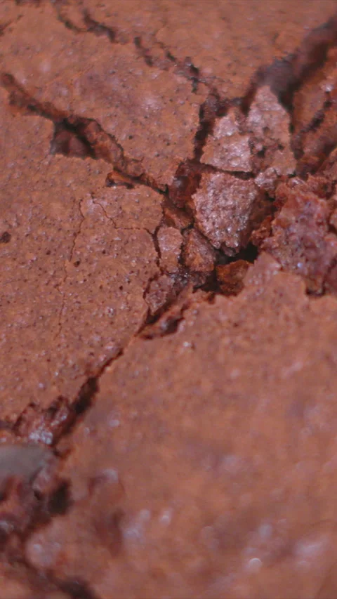 Vertical Video Close-up of Knife Breaking and Cutting into Delicious Chocolate Stock Footage 340839865