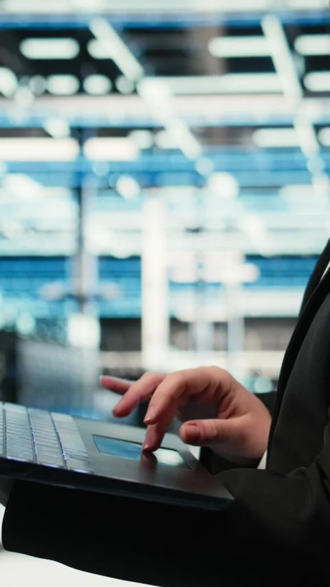 Vertical video Close up of laptop software used by data center admin to do Stock Footage 329316734