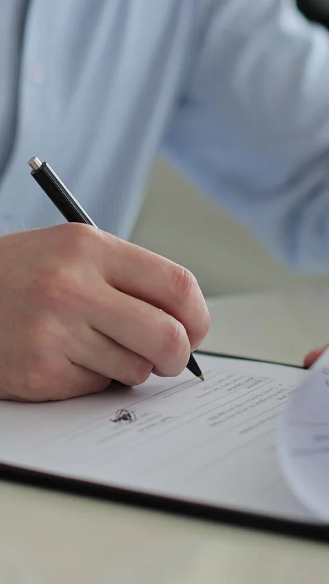 Vertical video Close up of man buying a car and signing the contract Stock Footage 337239299