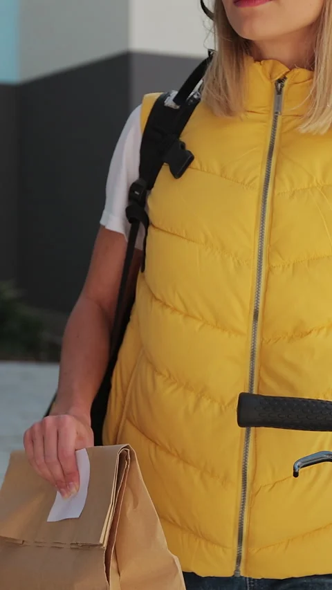 Vertical video. Close up Man customer open door to a food delivery woman Stock Footage 344373716