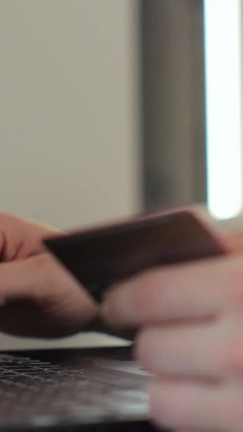 Vertical video. Close-up of man hands pressed the credit card code to pay online Stock-Footage 347780404