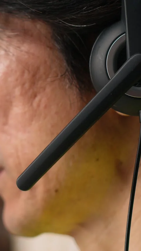 Vertical Video Close up of man in hi vis vest answers a customer service call Stock Footage 312579409