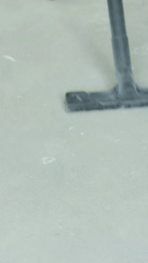 Vertical video Close up of man worker vacuums the floor Stock Footage 339060144