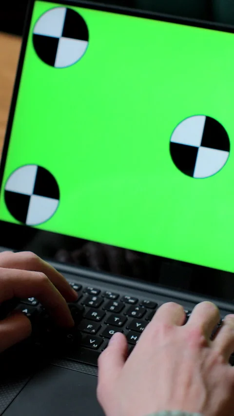 Vertical video. Close up of man working on laptop with green screen Video stock 345236008