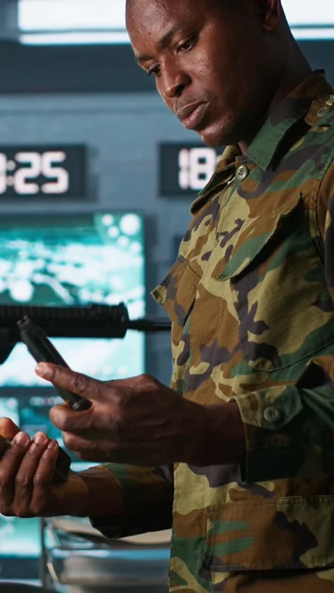 Vertical video Close up of military unit in command center packing handgun Stock Footage 281948851