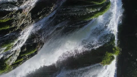 Vertical video: Close up of a natural waterfall with river water in a forest. Stock Footage 157615610