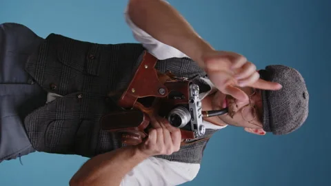 Vertical video of close up old fashioned photographer wearing glasses and retro Stock Footage 168018448