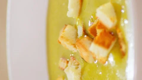 Vertical video. Close up of pieces of dried white bread falling into the cream Vídeos de archivo 250454442