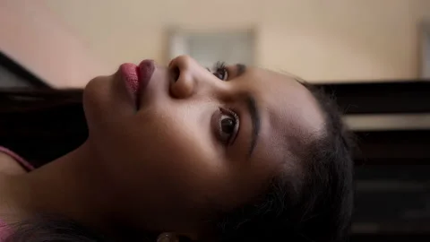 Vertical video. Close-up portrait of an African-American girl looking out the Stock Footage 150664679