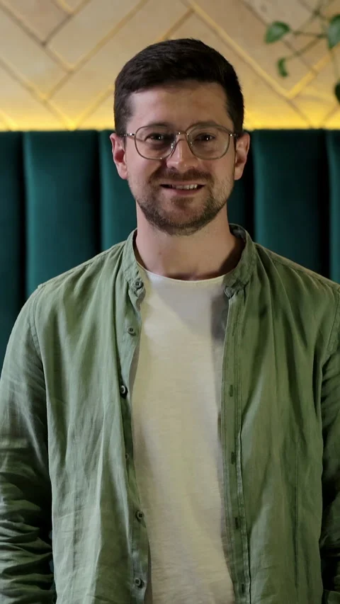 Vertical video. Close-up portrait of a joyful young professional with glasses Stock Footage 345237882