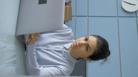 Vertical Video Close-Up Portrait Of A Young Indian Woman Typing on A Keyboard Stock Footage 150692476