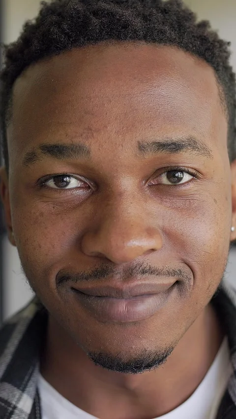 Vertical Video: Close up portrait of a young African American teenager smiling Stock Footage 297468161