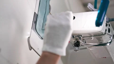 Vertical video close up professional dry cleaner young girl hems a patch on a Video stock 277166644