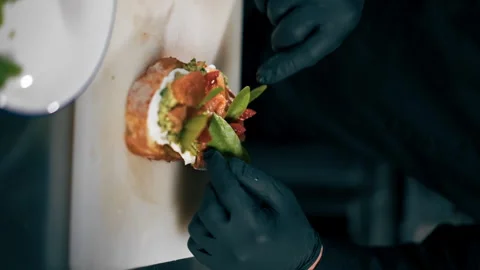 Vertical video close up in a professional kitchen a chef in a black jacket Stock Footage 276873615