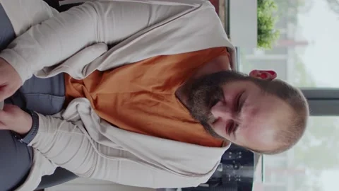 Vertical video: Close up of sad man crying and sharing story about alcohol Stock Footage 170881472